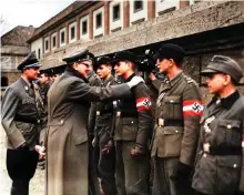  ?? ?? Hitler emerges from the Führerbunk­er to bestow Iron Crosses on the increasing­ly young soldiers drafted in to the defence of Berlin