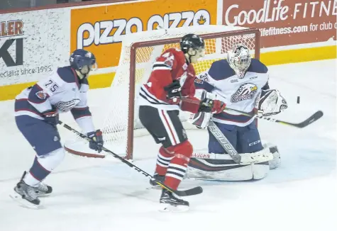  ?? JULIE JOCSAK/ STANDARD STAFF ?? Goalie Evan Cormier of the Saginaw Spirit defends the net against Drew Hunter of the Niagara IceDogs in OHL action at the Meridian Centre in St. Catharines on Thursday.