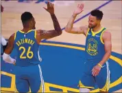  ?? JOSE CARLOS FAJARDO — STAFF PHOTOGRAPH­ER ?? The Warriors’ Kent Bazemore high-fives Stephen Curry after a basket against Denver on Monday. Curry surpassed Wilt Chamberlai­n as the franchise scoring leader.