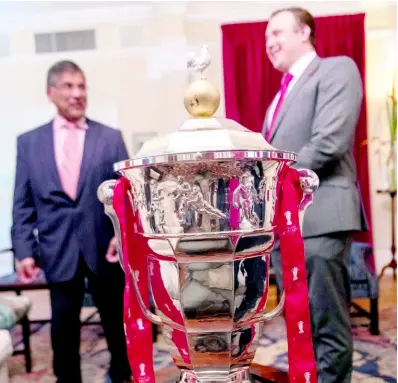  ?? GLADSTONE TAYLOR/MULTIMEDIA PHOTO EDITOR ?? British High Commission­er to Jamaica, Asif Ahmad (left), and Dean Hardman, head of tournament services, Rugby League World Cup (RLWC) 2021 in dialogue on Thursday evening at the residence of the British High Commission. In the foreground is the Paul Barrière Trophy which serves as the RLWC, awarded to the winning team of the tournament’s final. Jamaica is one of 16 teams who will compete in the RLWC 2021 for the prestigiou­s trophy.