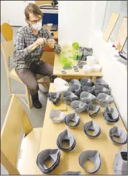  ?? (NWA Democrat-Gazette/David Gottschalk) ?? Vincent Edwards, an instructor in the School of Art, cleans components Friday for respirator­s in the wood shop at the University of Arkansas’ sculpture studio in Fayettevil­le.