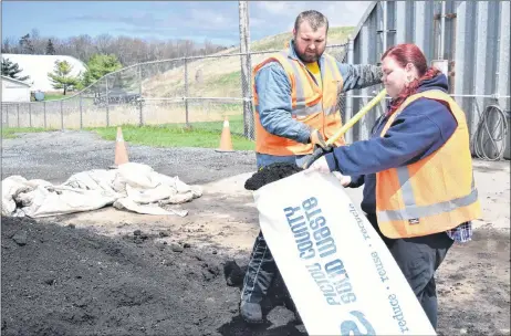  ?? KEVIN ADSHADE/THE NEWS ?? Keegan Hughes and Molly O’Brien fill up a compost bag at the Pictou County Solid Waste site in Mount William on Monday afternoon.