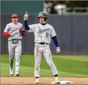  ?? JASON ALLEN/ASSOCIATED PRESS ?? Outfielder Drew Burress signals to the Yellow Jackets dugout after stroking a double during Saturday’s 8-5 win over North Carolina State. Georgia Tech’s four victories last week ran its streak to eight.