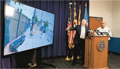  ?? KENNETH K. LAM/BALTIMORE SUN ?? Baltimore Police Commission­er Michael Harrison, right, and Deputy Commission­er Brian Nadeau, who leads the department’s Public Integrity Bureau, show an edited video of last week’s police shooting that critically wounded a 17-year-old boy.