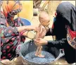  ?? HAMMADI ISSA — THE ASSOCIATED PRESS ?? A severely malnourish­ed infant is bathed in a bucket in Aslam, Hajjah, Yemen, on Aug. 25. Around 2.9 million women and children are acutely malnourish­ed in the country.