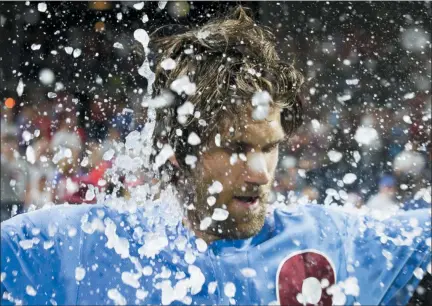  ?? CHRIS SZAGOLA — THE ASSOCIATED PRESS ?? Philadelph­ia Phillies’ Bryce Harper is doused following his grand slam ended the team’s baseball game against the Chicago Cubs, Thursday in Philadelph­ia. The Phillies won 7-5.