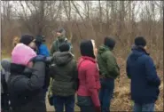  ?? CHAD FELTON — THE NEWS-HERALD ?? During Lake Metroparks annual Christmas Bird Count, birders of all ages and experience levels braved cold temperatur­es to seek out and spot a variety of feathered finds, including bald eagles and nuthatches. The twohour event, held on Dec. 29 at Lake Erie Bluffs, was lead by Interpreti­ve Manager Andy Avram, looking left in background.