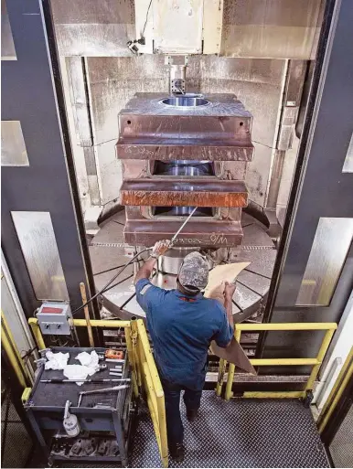  ?? Melissa Phillip / Houston Chronicle file ?? A machinist at Houston-based National Oilwell Varco works on a part for a blowout preventer.