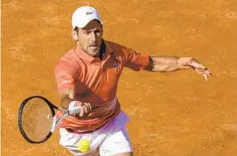  ?? ANDREW MEDICHINI AP ?? Novak Djokovic takes another step in the right direction in finding his form with a 6-3, 6-2 win over Aslan Karatsev in his opening match at the Italian Open.