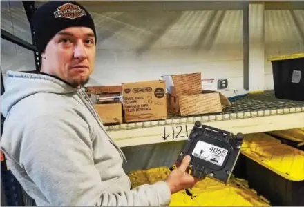  ?? DONNA ROVINS — DIGITAL FIRST MEDIA ?? Pottstown’s Scavenger Cycles’ inventory system lets them know exactly where a part is being stored in the warehouse area. In this photo, Scavenger Cycles owner Stan Alemaskin displays one of the inventory numbers. The company recently relocated to...