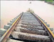  ??  ?? (Clockwise from top) A bridge on Gujarat’s Deesa Dhanera highway is washed away in floods; A rickshaw wades through a waterlogge­d street following heavy rains in Allahabad; BhaildiPal­anpur railway track in state’s Patan district is submerged on...