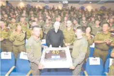  ?? (Mark Neyman/GPO) ?? PRESIDENT REUVEN RIVLIN receives a birthday cake on the occasion of his 80th birthday, which coincided with his visit to the IDF Commando Brigade.