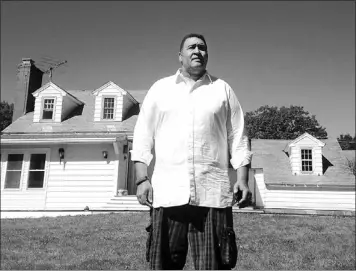  ?? — Photo by The Associated Press ?? Former NFL offensive lineman Brian Holloway stands in front of his rural vacation home in Stephentow­n, N.Y., on Wednesday. The house was trashed during a Labour Day weekend party attended by an estimated 200 to 400 teenagers. Holloway said the partiers...