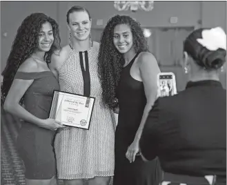  ?? SEAN D. ELLIOT/THE DAY ?? New London’s India Pagan, right poses with sister Tai, left, and former Stonington great Heather Buck at the conclusion of The Day High School Athlete of the Year Awards banquet last June at the Port ‘N Starboard banquet hall at Ocean Beach Park. Tai Pagan was the girls’ basketball player of the year for 2019, India was honored in 2017, and Buck won the honor four times.