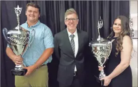  ?? Scott Herpst ?? Ridgeland Athletic Director Tim Sparks stands with Logan Montgomery and Mackenzie Hunter. The pair were named as the 2021-22 Vonn Bell Awards winners, signifying the school’s male and female Student-Athletes of the Year. The awards were part of the annual Ridgeland Athletic Hall of Fame inductions, held on May 14.