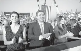  ?? DOUG MILLS/THE NEW YORK TIMES 2020 ?? Florida Gov. Ron DeSantis, seen with his wife Casey, left, and Kimberly Guilfoyle, may be emerging as the face of the post-Trump right.