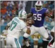  ?? LYNNE SLADKY — THE ASSOCIATED PRESS ?? Buffalo Bills defensive end Jerry Hughes (55) jumps to block a pass by Miami Dolphins quarterbac­k Ryan Tannehill (17) during the first half of an NFL football game last week in Miami Gardens, Fla.