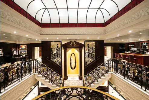  ??  ?? Staterooms and suites are infused with state-of-the art-technology and stylish surroundin­gs; the stunning atrium is a relaxed, luxurious gathering space.