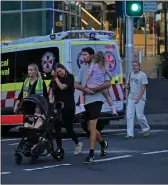  ?? Picture: AP Photo ?? People are led out of the Westfield shopping centre in Sydney