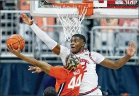  ?? PAUL VERNON / AP ?? Ohio State forward E.J. Liddell tries to block a shot by Illinois guard Adam Miller during Saturday’s game. Liddell has been named to the AP All-Big Ten first team.