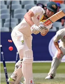  ?? PHOTO: DEAN LEWINS ?? KNOCKED OVER: Shaun Marsh is bowled by England's Chris Woakes for 19 as Australia collapsed on Day 4 of the second Ashes Test in Adelaide.