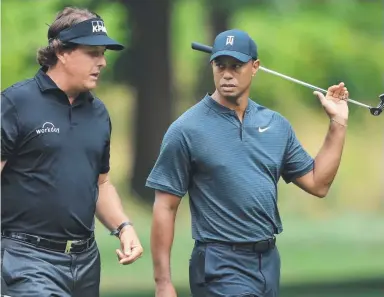  ?? Picture: AFP ?? Phil Mickelson and Tiger Woods chat during a preview day of the World Golf Championsh­ips.