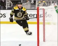  ?? Adam Glanzman / Getty Images ?? The Bruins’ Brad Marchand scores in an open net in the third period against the Hurricanes in Game 4 of a Stanley Cup first-round playoff series on Sunday in Boston.