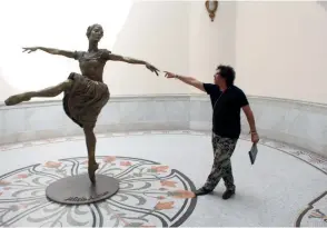  ??  ?? Alexis Miguel Pantoja junto a su escultura de Alicia en el Gran Teatro de La Habana.