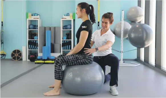  ?? Pawan Singh / The National ?? Amy Gilbert teaches proper posture to a client. The physiother­apist says conditions such as text neck are not confined to adults