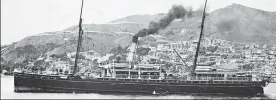  ?? Photos / Alexander Turnbull Library ?? Men haul wreckage and a body from the surf at Cape Terawhiti, Wellington, after the wreck of the steamship Penguin (left) in February 1909.