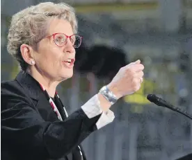  ?? DAVE CHIDLEY, CP ?? Ontario Premier Kathleen Wynne promises payments of nearly $17,000 a year for any eligible person aged 18 to 64. It will cost the government $50 million.