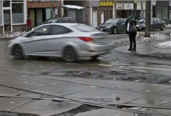  ?? LUCAS OLENIUK/TORONTO STAR ?? The freeze-thaw cycle hasn’t been kind to the corner of Dundas St. E. and Broadview Ave.