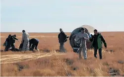  ?? PHOTO / AP ?? NASA astronaut Nick Hague and Roscosmos’ Alexei Ovchinin plummeted back to earth after their Soyuz rocket malfunctio­ned.