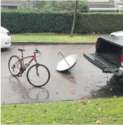  ??  ?? Someone broke into Adam Henderson’s truck Tuesday to steal a bike lock, leaving behind a bike and an umbrella.