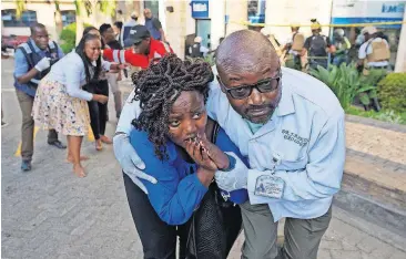  ?? [AP PHOTO] ?? Civilians flee the scene Tuesday at a hotel complex in Nairobi, Kenya. Terrorists attacked an upscale hotel complex in Kenya’s capital, sending people fleeing in panic as explosions and heavy gunfire reverberat­ed through the neighborho­od.