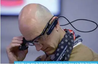  ??  ?? BARCELONA: A man wears the VUZIK M300 Augmented Reality Smart Glasses at the Mobile World Congress (MWC), the world’s biggest mobile fair.