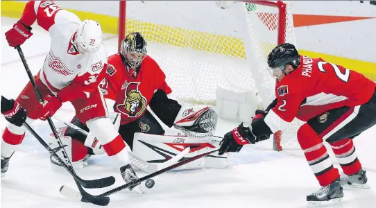  ?? FRED CHARTRAND/THE CANADIAN PRESS ?? Senators defenceman Dion Phaneuf raps Detroit Red Wings’ Evgeny Svechnikov’s stick in front of goalie Craig Anderson Tuesday night in Ottawa.