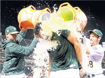  ?? PHOTOS: RAY CHAVEZ — STAFF PHOTOGRAPH­ER ?? Athletics pitcher Sean Manaea receives a celebrator­y dousing from teammates after pitching a no-hitter against Boston on April 21.