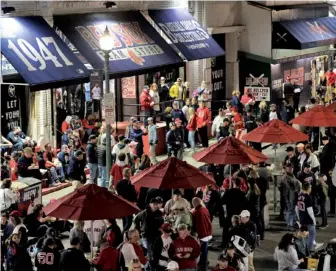 ?? STAFF PHOTOS BY CHRISTOPHE­R EVANS ?? BIG SPENDERS: Fans gather on Jersey Street last night outside Fenway Park for Game 2 of the Red Sox-Yankees playoff series, which is pumping millions into the local economy.