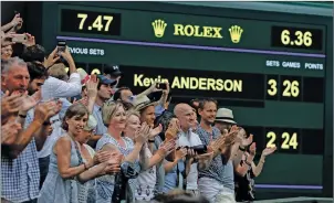  ?? AP PHOTO ?? Spectators applaud as the scoreboard displays the final score in the men’s singles semifinals match at Wimbledon in which South Africa’s Kevin Anderson defeated John Isner of the United States.