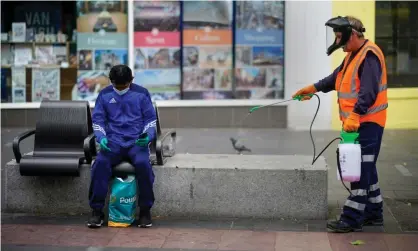  ?? Photograph: Christophe­r Furlong/Getty Images ?? A council worker disinfects street furniture in Leicester.