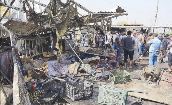  ?? AP ?? Citizens inspect one of the crowded outdoor markets hit by a spate of car bombs in Baghdad’s Sadr City on Tuesday.