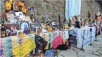  ?? PHOTOS BY TONY MARINELLA ?? Community ofrendas, or altars, are part of the fun at the Celebracio­nes de la Gente festival in Flagstaff.