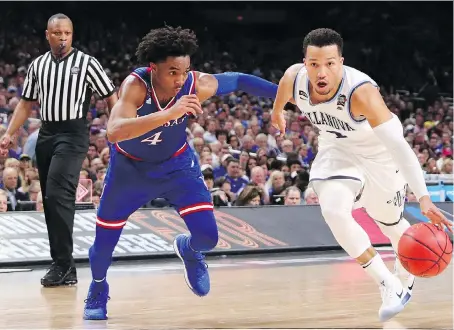 ?? TOM PENNINGTON/GETTY IMAGES ?? Villanova University Wildcats guard Jalen Brunson, right, is defended by the University of Kansas Jayhawks guard Devonte’ Graham in the second half of their NCAA Final Four semifinal Saturday in San Antonio. Bruson had 18 points and six assists in a...