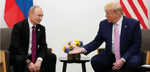  ?? (Kevin Lamarque/Reuters) ?? US PRESIDENT Donald Trump gestures towards Russian President Vladimir Putin during a meeting at the G-20 summit last June in Osaka. Now he wants to invite him to the G-7.