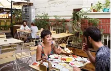  ??  ?? Customers enjoy breakfast at a local cafe