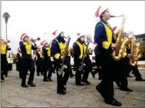  ??  ?? Earl Warren Junior High’s marching band performs during Saturday’s NOR Christmas Parade.