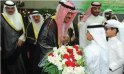  ??  ?? Children present flowers to His Highness the Crown Prince Sheikh Nawaf Al-Ahmad Al-Jaber Al-Sabah during his visit to the Kuwait Sports Club for the Deaf.