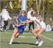  ?? Dave Stewart/Hearst Connecticu­t Media ?? Darien's Ryan Hapgood (17) battles New Canaan's Lexie Tully (23) during a girls lacrosse game at Dunning Field in April.]