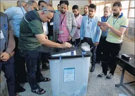  ?? Ali Abbas EPA/Shuttersto­ck ?? AN INDEPENDEN­T High Electoral Commission worker seals a ballot box at the end of voting in Baghdad. Nearly 7,000 candidates ran for 329 parliament­ary seats.